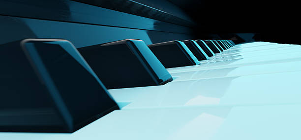 A detailed look at piano keys, softly lit in blue, showcasing their glossy surfaces and unique textures.