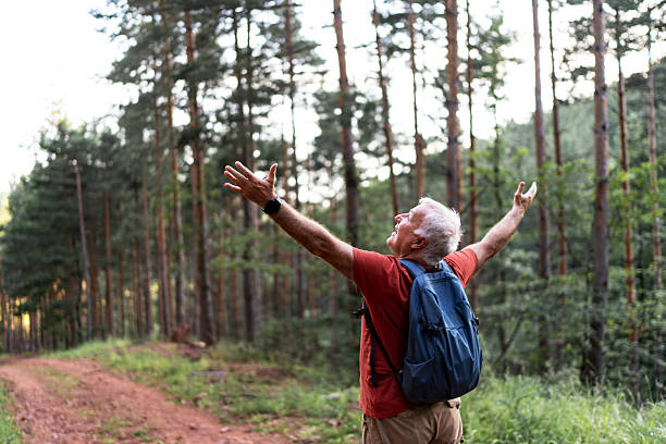 istock Senior man enjoying nature in forest 2210685554