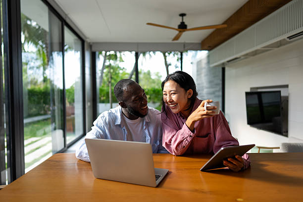 istock Remote work and digital business. Diverse couple collaborating online, managing projects with laptop 2210687965