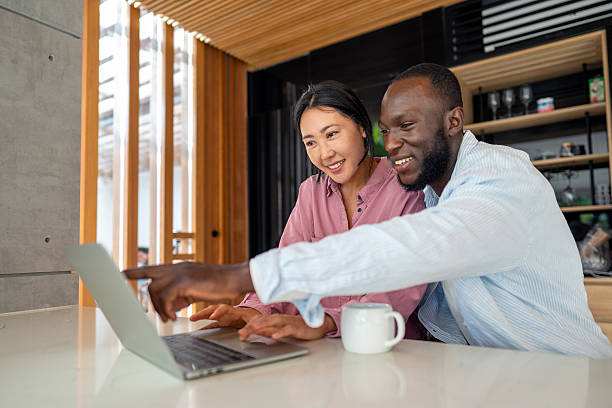istock A happy, multi-national couple who are digital nomads and work from a different country every month 2210689744