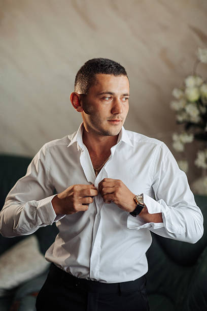 istock A man in a white shirt is adjusting his collar 2210689953