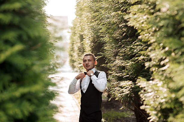 Portrait of a young businessman in a public park outdoors.
