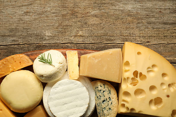istock Different types of cheese on wooden table, top view. Space for text 2210692689