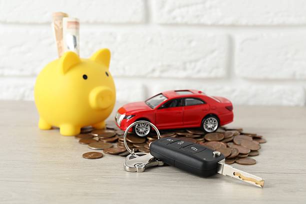 istock Car key, model, piggybank and coins on light background 2210693002