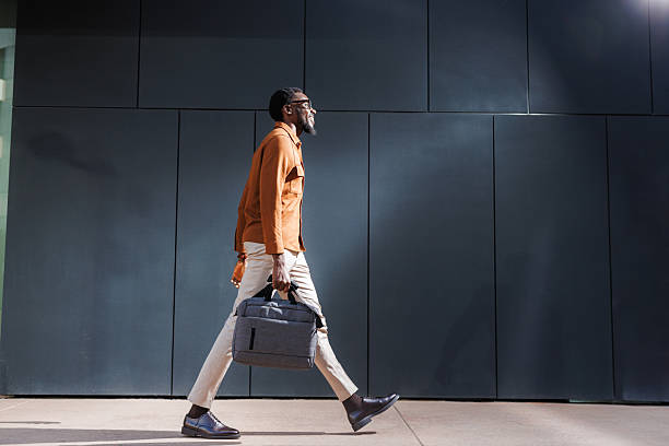 istock Business professional walking confidently carrying a laptop bag 2210693206