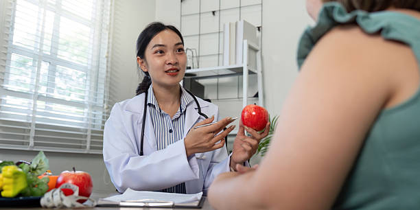 istock Client Consultation and Nutrition Education. A nutritionist discusses dietary strategies while engaging with a client. 2210693954