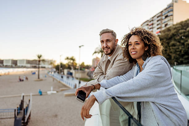 istock Smiling Couple Enjoying Scenic Views at a Beachfront Promenade 2210694062