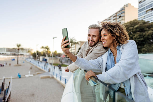 istock Friends Taking a Selfie Together Outdoors on a Sunny Day by the Beach 2210694090