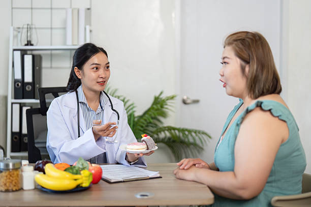 istock Nutritionist Communication and Client Interaction. A nutritionist discusses dessert options while promoting healthy choices. 2210694318