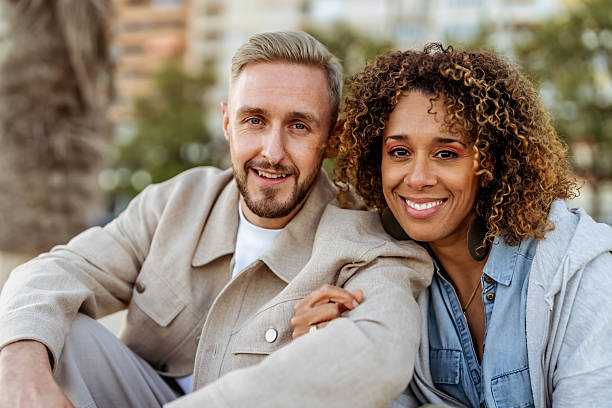 istock Smiling Couple Posing Outdoors Together in Urban Park Setting 2210695381
