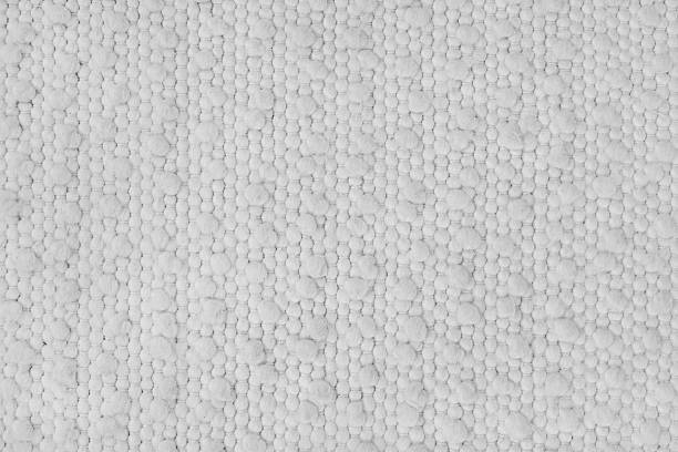 istock Texture of white carpet fabric with large coarse textured weaving. Upholstery, cloth background 2210695921