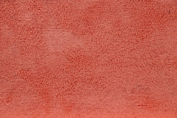 istock The shaggy soft surface of the coral-colored case as a background 2210698824