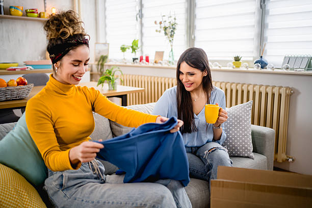 istock Two young women unpacking clothes at home 2210699051