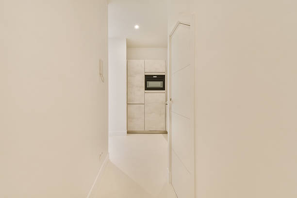 interior of long bright hallway with white walls anf white floor