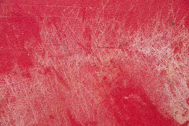 istock Red plastic kitchen cutting board with scratches and cuts as background 2210699970