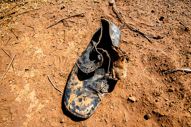 old broken leather shoe abandoned in the sand among the stones of the Moroccan Atlas near Ouarzazate Morocco