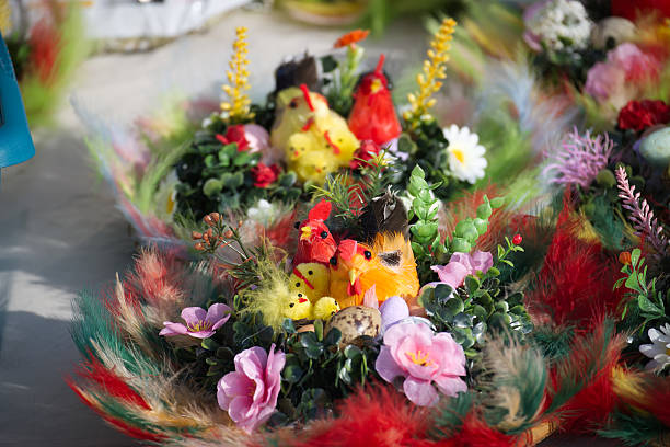 Festive Easter table centerpieces decorated with colorful chicks, feathers, flowers and speckled eggs create a whimsical spring display.