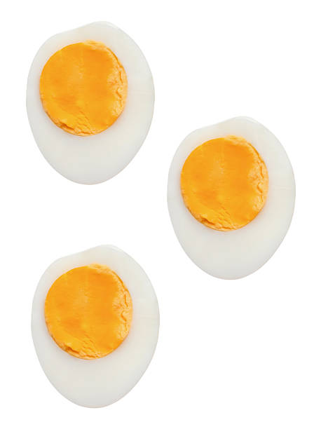 istock Top view set of unpeeled cooked or boiled chicken eggs in three halves with egg yolks isolated on white background with clipping path 2210707263