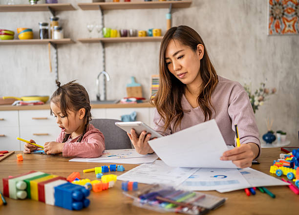istock Mother working from home while daughter plays with toys 2210707540