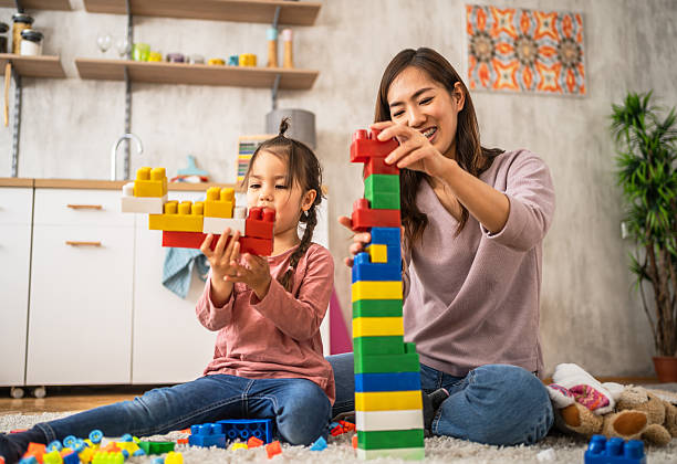 istock Mother and daughter building with blocks at home 2210707622