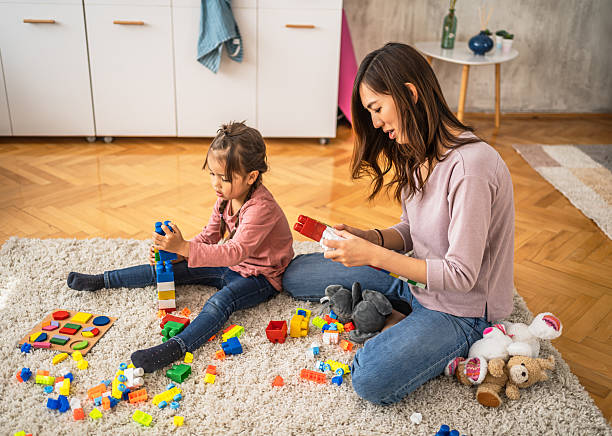 istock Mother and daughter playing with building blocks at home 2210707740