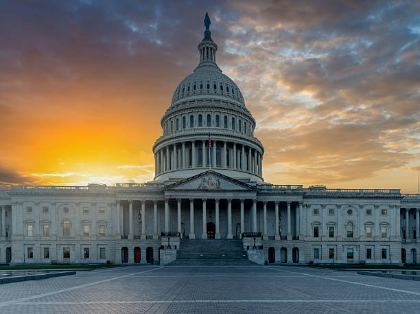 istock United States Capitol Building under a shining a sun at sunset 2210707928