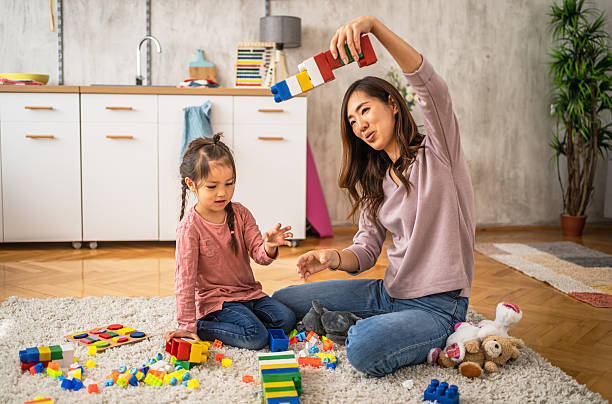 istock Mother and daughter playing with building blocks at home 2210708156