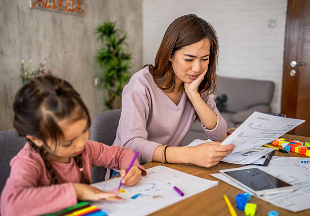 istock Mother worried about bills while daughter is drawing 2210708321