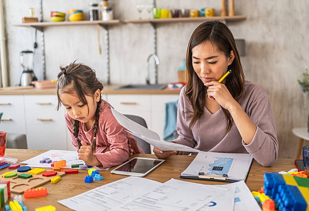 istock Worried mother going through her financials 2210708421