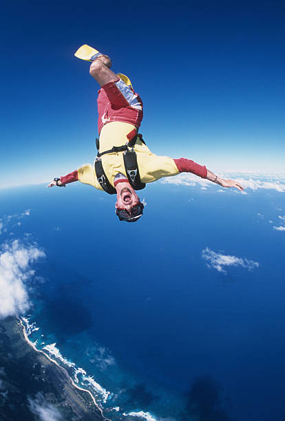istock Man sky surfs above clouds and ocean 2210708492