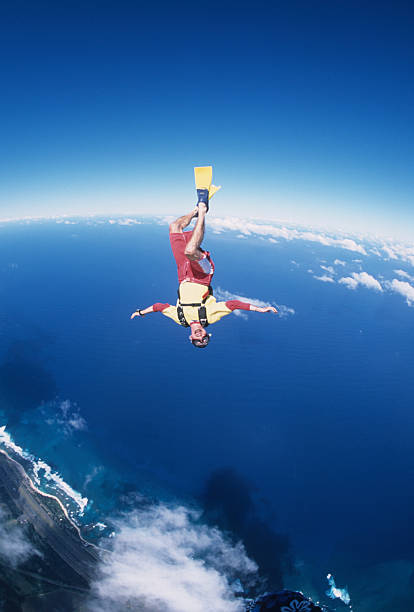 istock Man sky surfs above clouds and ocean 2210708549