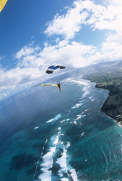 istock Skydiver soars through sky with streamers above ocean 2210708682