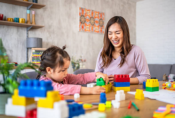 istock Asian mother and daughter having fun playing with building blocks 2210708893