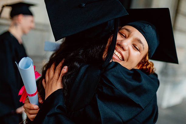 istock Two happy students hugging at graduation ceremony 2210711809