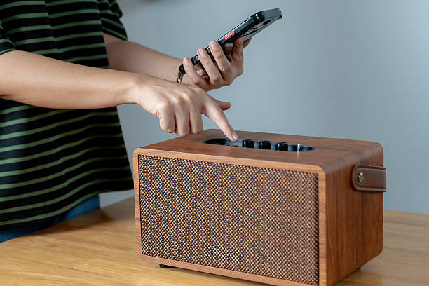 istock A young woman connecting a Bluetooth speaker to her smartphone 2210713180