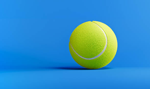 istock Yellow Tennis Ball On Blue Background 2210715505