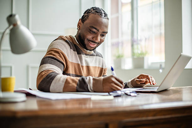 istock Young man engaged in online classes from home while studying and enjoying a cheerful atmosphere 2210715746