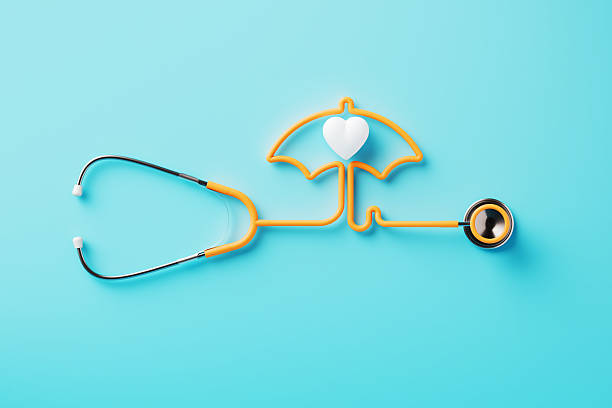 istock Orange Stethoscope Forming An Umbrella Shape Around A White Heart On Blue Background 2210715853