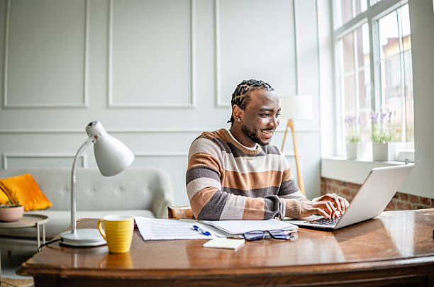 istock Young man engaged in online learning from a cozy home office, utilizing a laptop for education and communication 2210717171