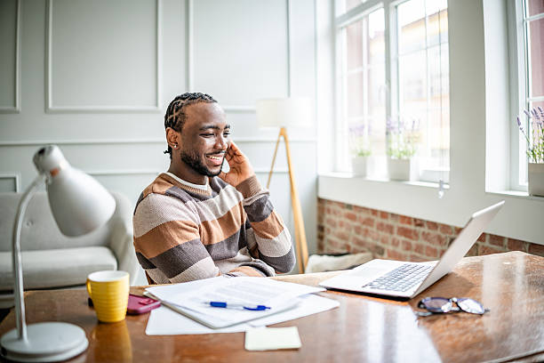 istock Young man enjoying online classes at home, engaging in learning and staying connected through technology 2210719301