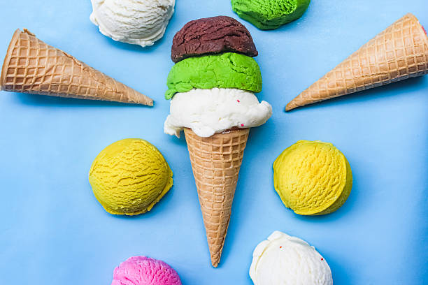 istock Stack of colorful ice cream scoops on blue background 2210719933