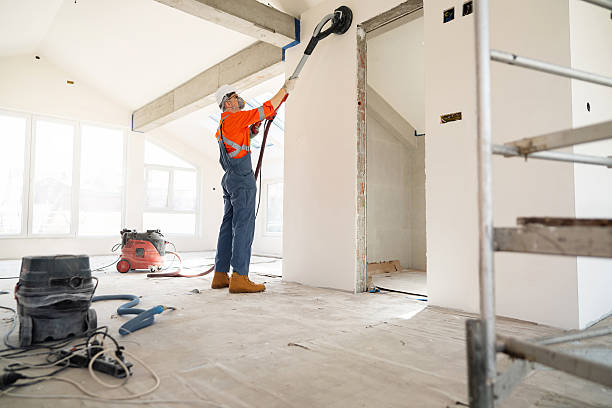 istock Craftsman sanding walls on a renovation project with specialized equipment 2210720357