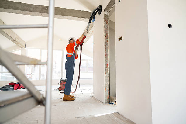 istock Craftsman sanding indoor wall surfaces during home renovation with specialized equipment 2210721562