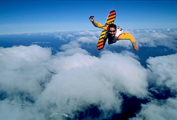 istock Man sky surfs above clouds and ocean 2210723988