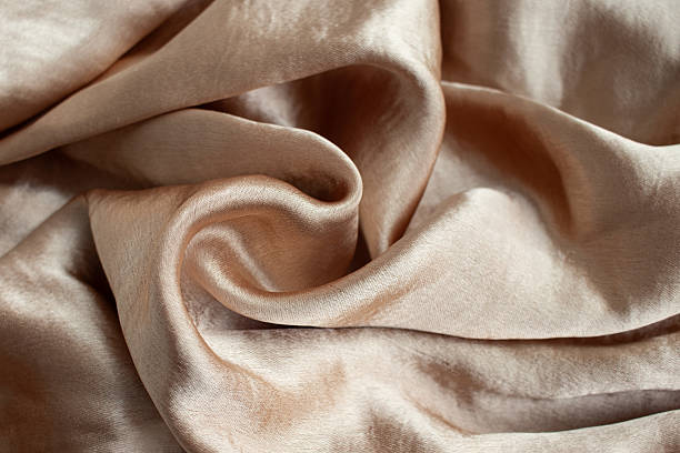 istock Silk fabric background. Shiny gold fabric 2210726964
