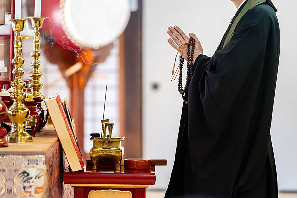 Image material of a monk praying at a Buddhist altar
