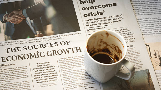 istock Newspaper with coffee on wooden table 2210730642