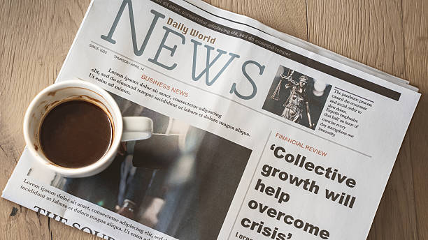 istock Newspaper with coffee on wooden table 2210730697