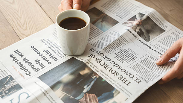 istock Reading the newspaper with coffee 2210730777