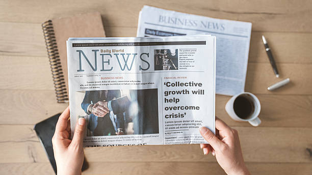 istock Reading the newspaper with coffee 2210730782